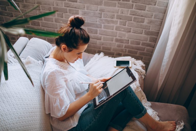 Woman using tablet illustrating remote work and business management tips