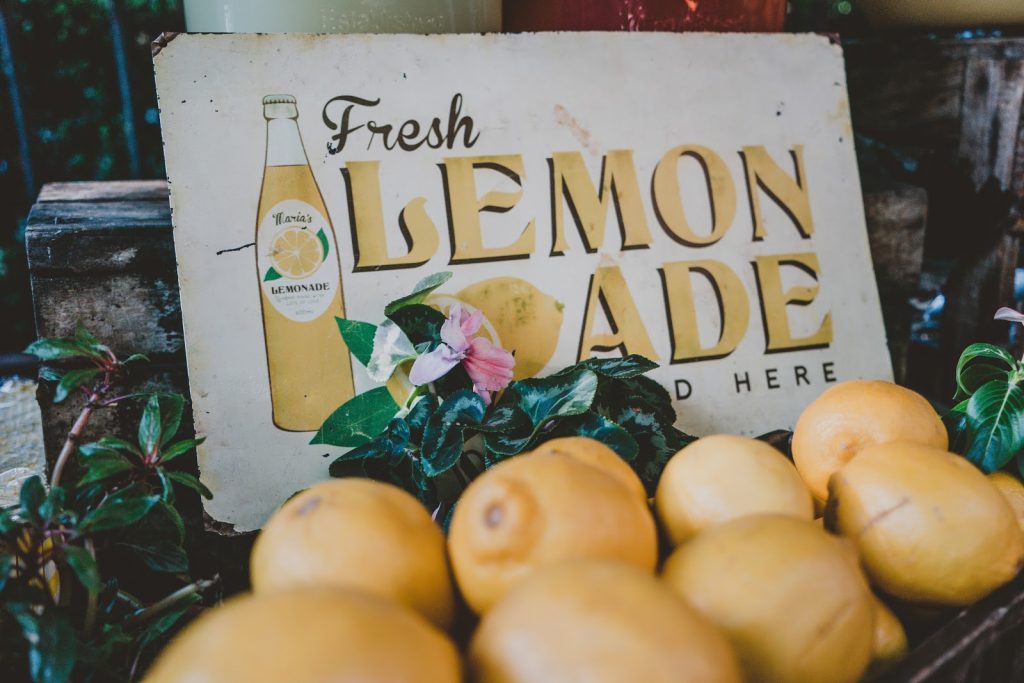 Fresh lemonade sign with lemons and greenery, illustrating ways to make fast cash.