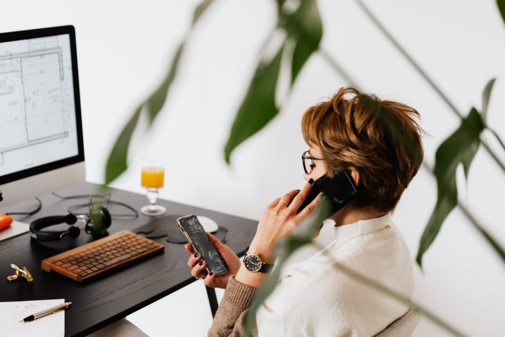 Woman on phone discussing sales outreach and customer interaction.