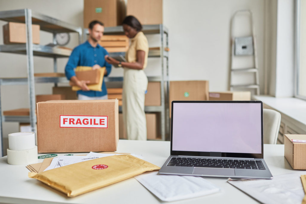 Amazon inventory management with NetSuite and shipping supplies on a table.