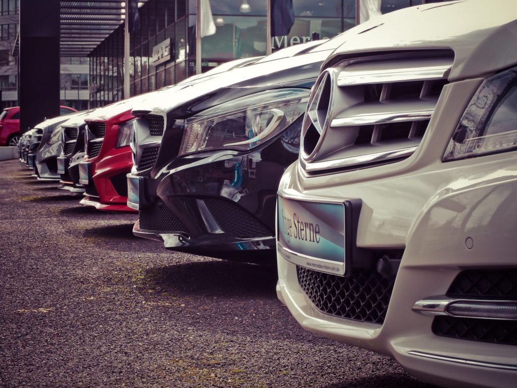 Rows of Mercedes-Benz vehicles in a dealership showroom, automotive industry career opportunities.