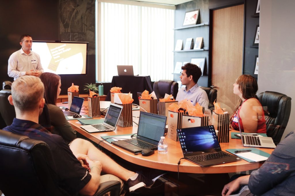 Business meeting discussing HRIS systems and employee data management.