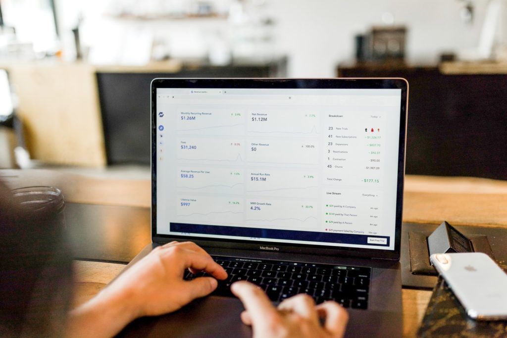 Laptop displaying financial data and business information for document access protection.