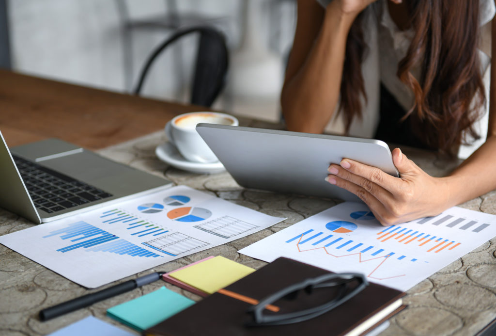 Female business professionals using tablet for business management and marketing analysis.
