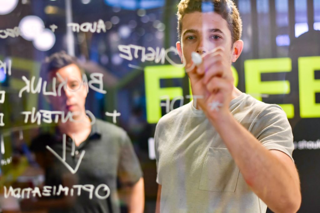 Man pointing at whiteboard illustrating SEO link building strategies