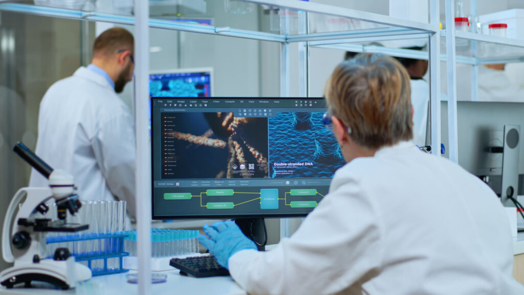 Medical research scientist typing codes on computer analyzing medical data