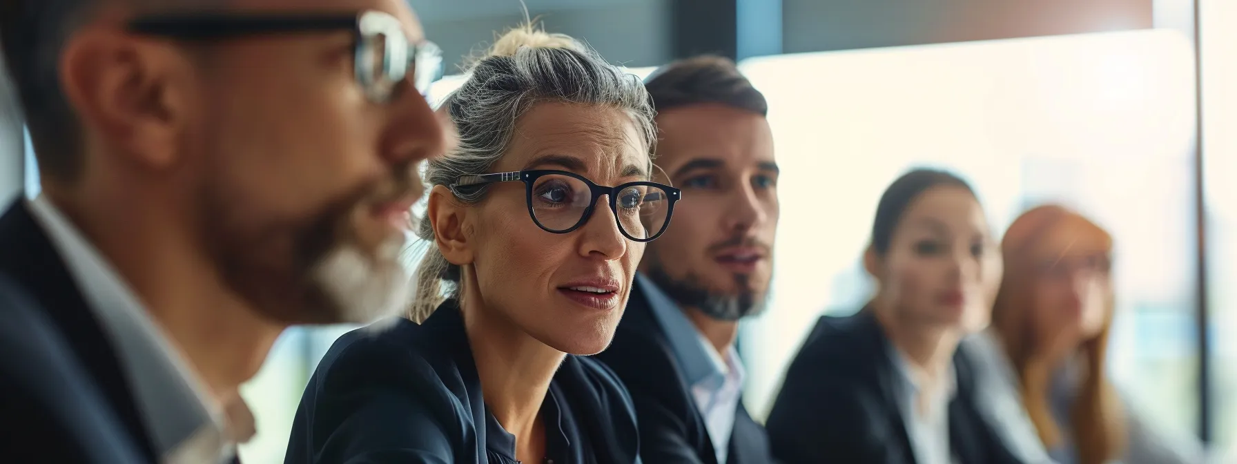 a group of business professionals engages in a focused discussion, reflecting on communication strategies.