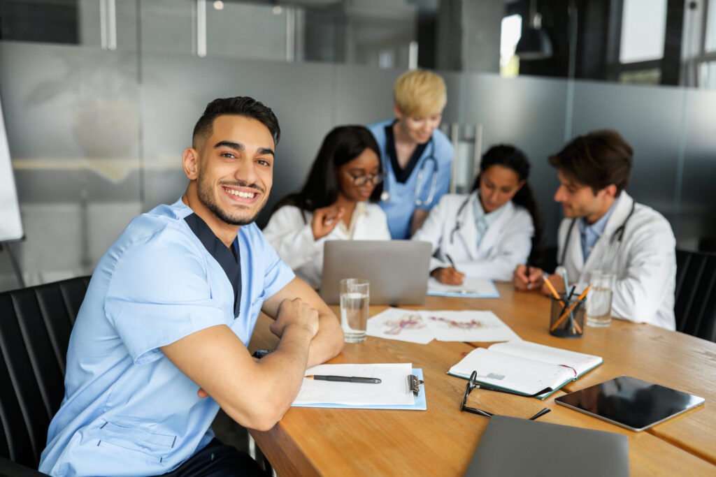 Smiling doctor and healthcare professionals collaborating in a medical setting.