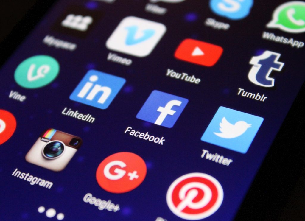 Social media icons on smartphone illustrating a social media presence for business.