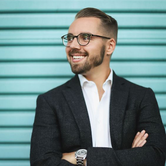 Learn More 26 Ben Ortega, Shoot for the Edit editorial intern, smiling and wearing glasses